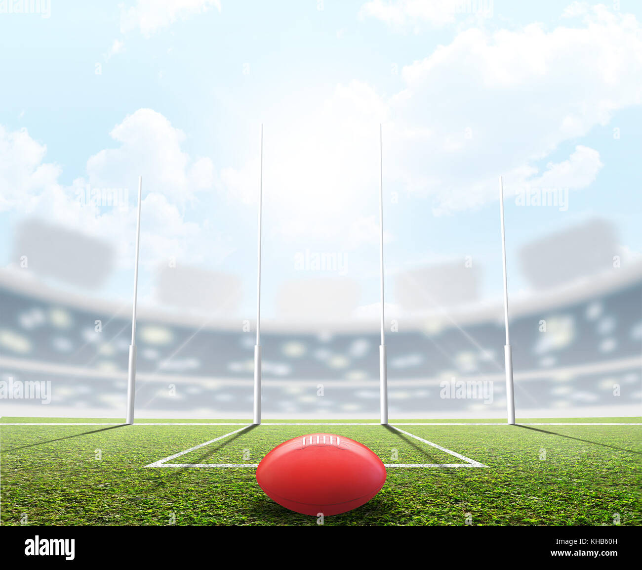 An aussie rules football stadium with a ball and goal posts in the daytime under a blue sky - 3D render Stock Photo