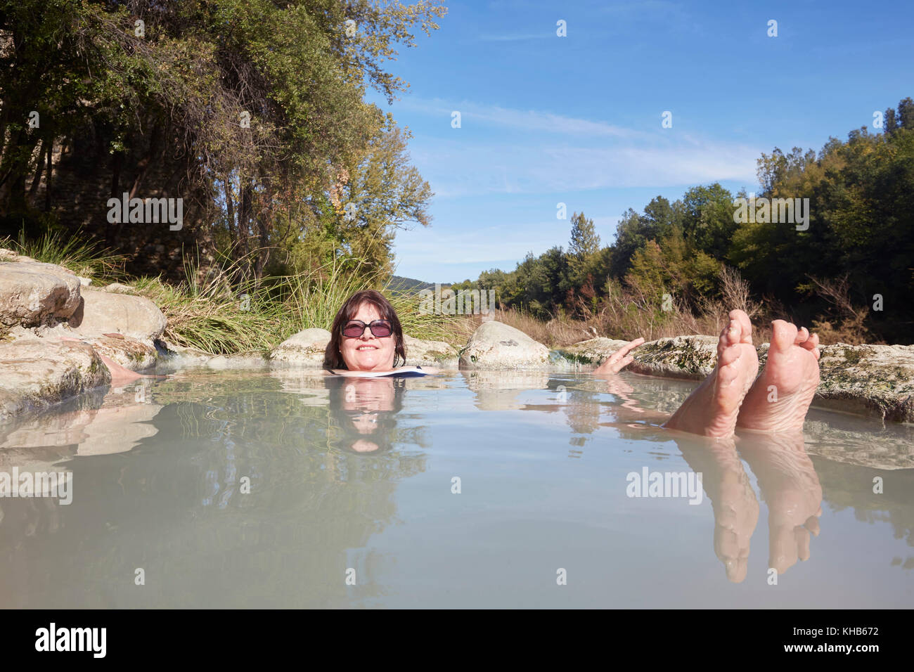 A swimmer in the geothermal hot springs on the River Farma, Bagni di Petriolo, district of Monticiano, Province of Siena, Tuscany, Italy. Stock Photo