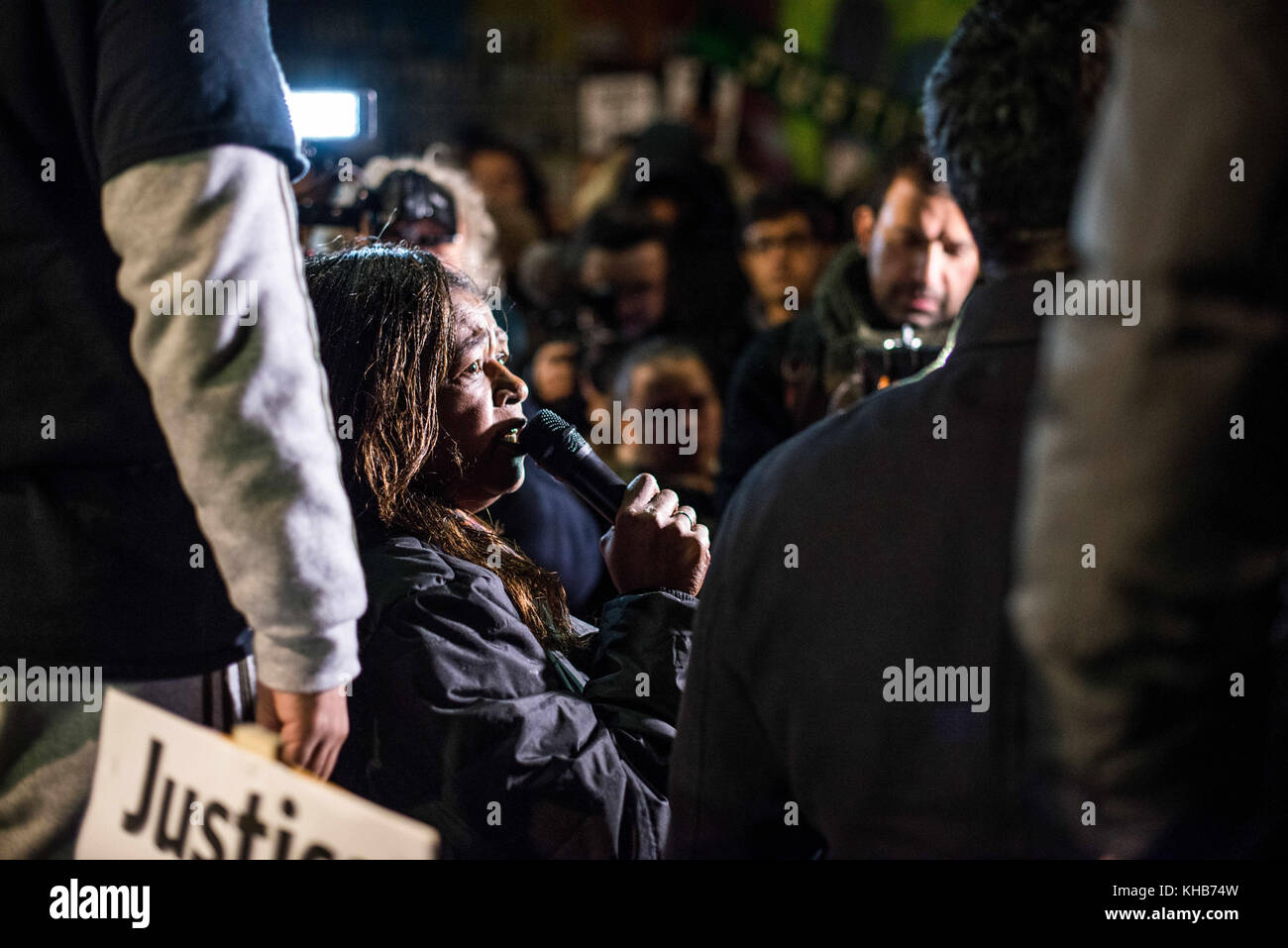 London, London, UK. 14th Nov, 2017. A local woman speak through the microphone during the monthly silent march for the Grenfell Tower fire victims.Around 1,000 people joined the monthly silent march at night to commemorate the victims of the Grenfell Tower fire. The march marks five months since the June 14 fire, which spread ferociously through the 24-storey west London block and killed 80 people. Credit: Brais G. Rouco/SOPA/ZUMA Wire/Alamy Live News Stock Photo