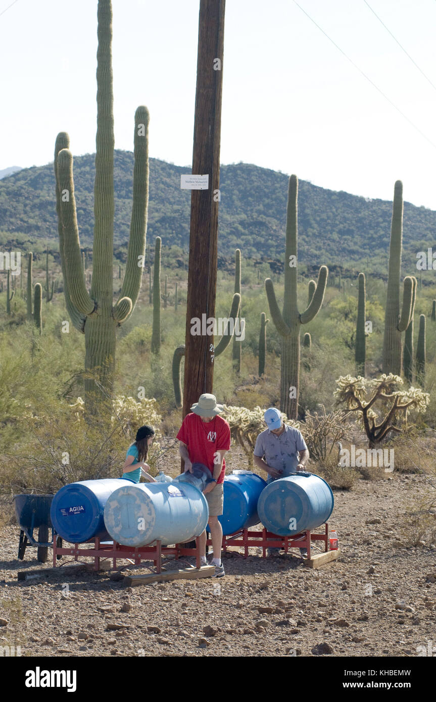 Ajo, Arizona, USA. 16th Oct, 2010. Humane Borders volunteer John Asher, Phoenix, left, fills water barrels while s Lawn Griffiths, Tempe, Ariz., check clorine levels, while restocking a water at a water station in Organ Pipe National Monument in the Sonoran Desert south of Ajo Arizona. Humane Borders maintains more than 100 water stations along the US/Mexico border in an effort to stem the death toll of migrants who enter the U.S., using the most dangerous and inhospitable routes through the desert. Although the number of people of illegally crossing into the U.S. through Arizona is down, Stock Photo