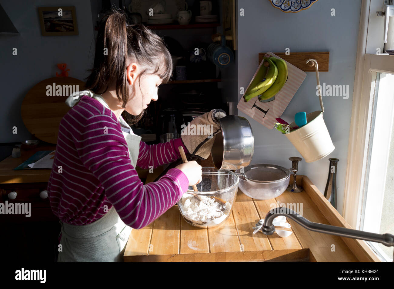 Twelve year old girl baking a cake at home Stock Photo Alamy