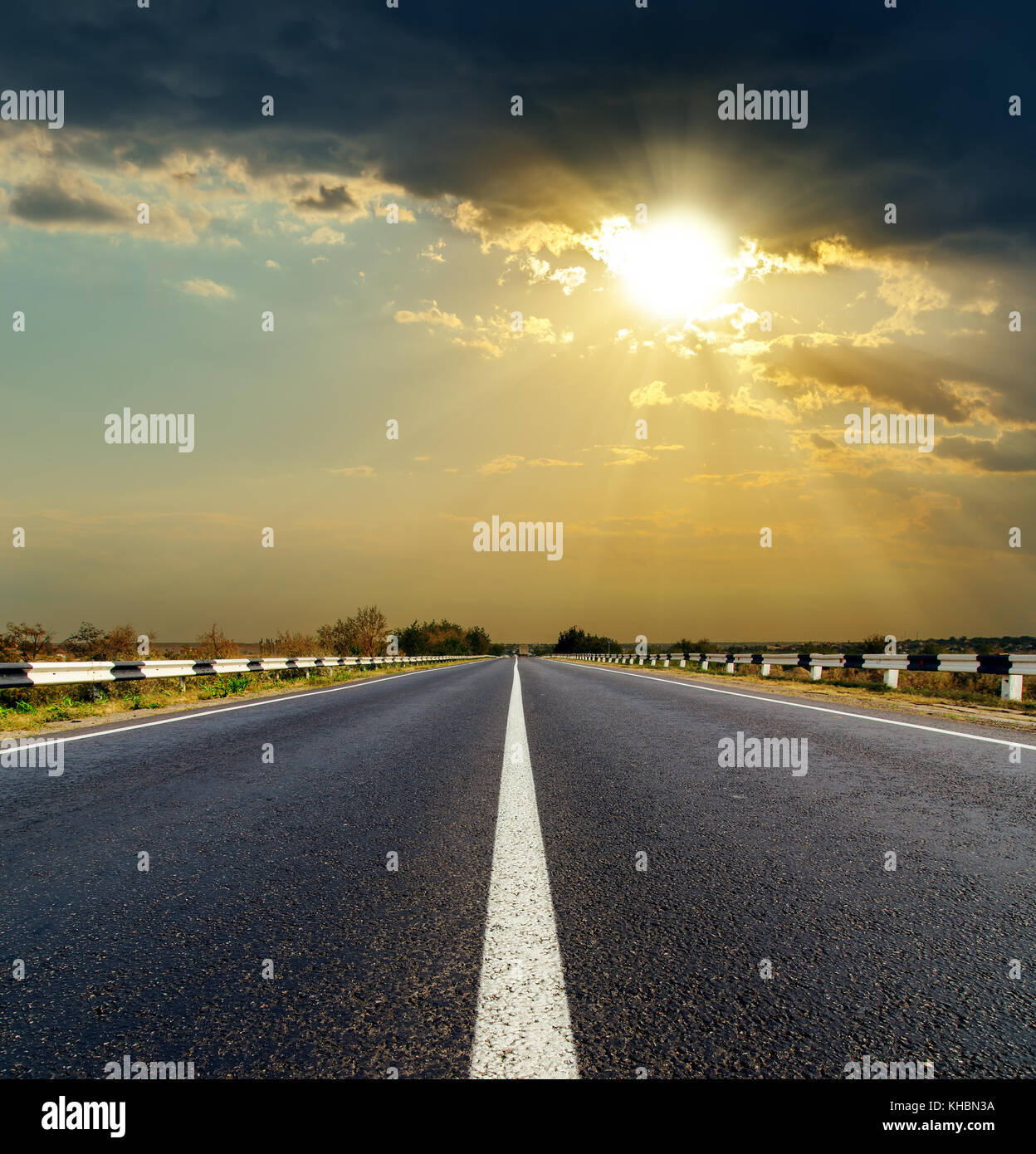 dramatic sunset over asphalt road Stock Photo - Alamy