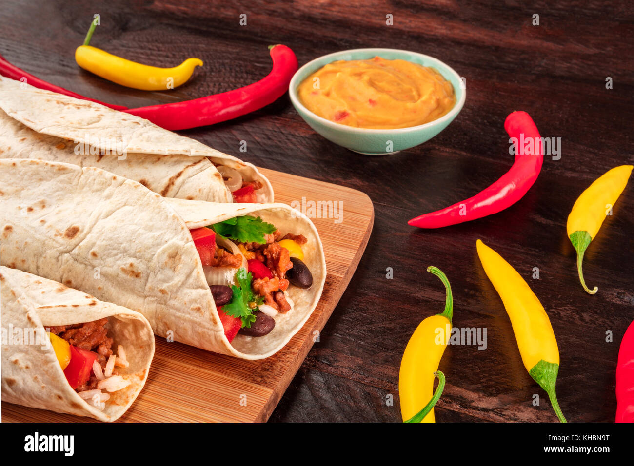 A closeup photo of Mexican burritos with beef, rice, black beans