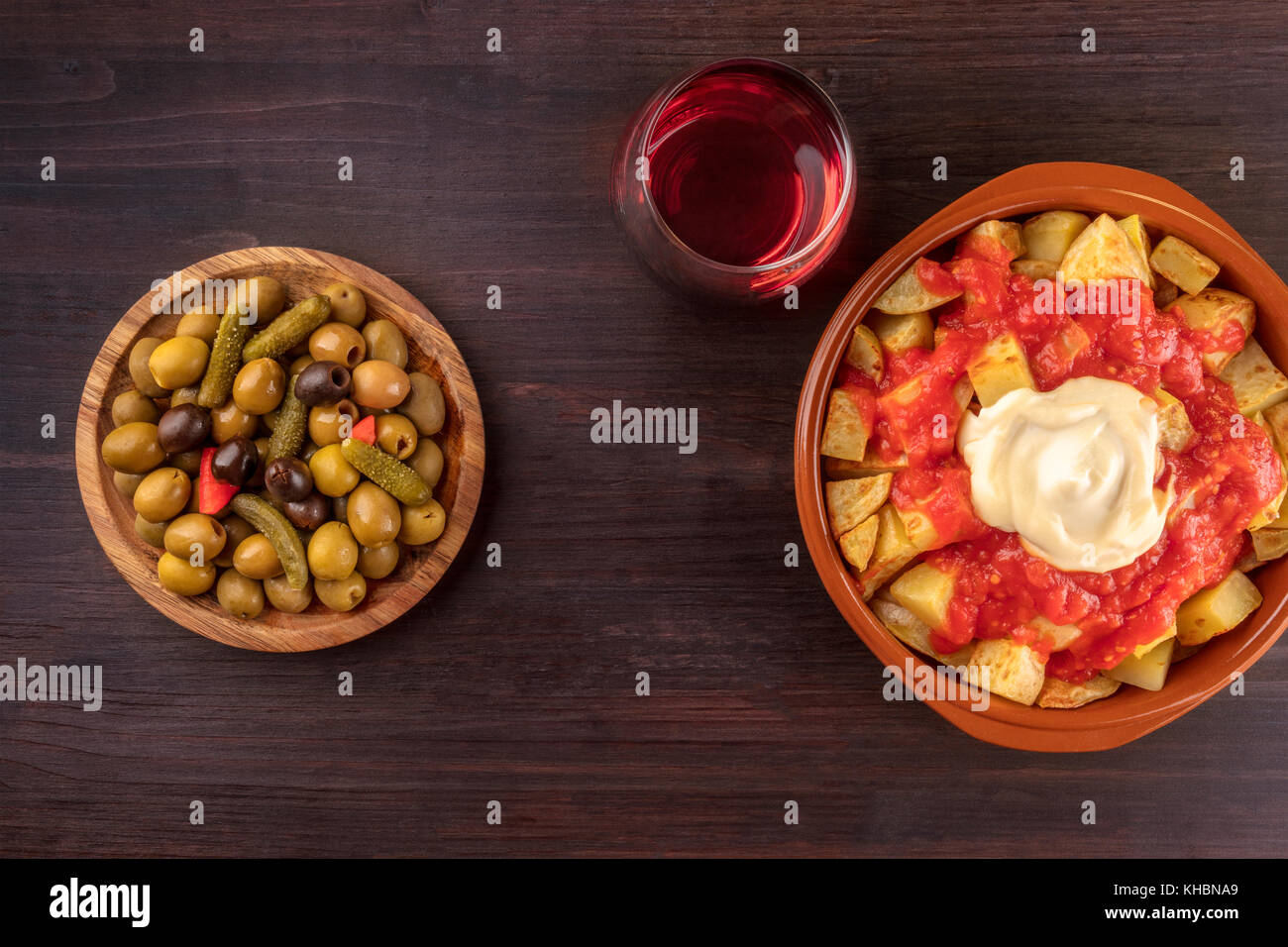 Overhead photo of traditional Spanish tapas. Pickled olives, patatas
