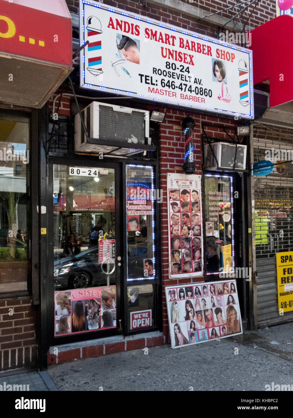 The exterior of Andis Smart Barber Shop on Roosevelt Avenue under the elevated subway in Jackson Heights, Queens, New York. Stock Photo