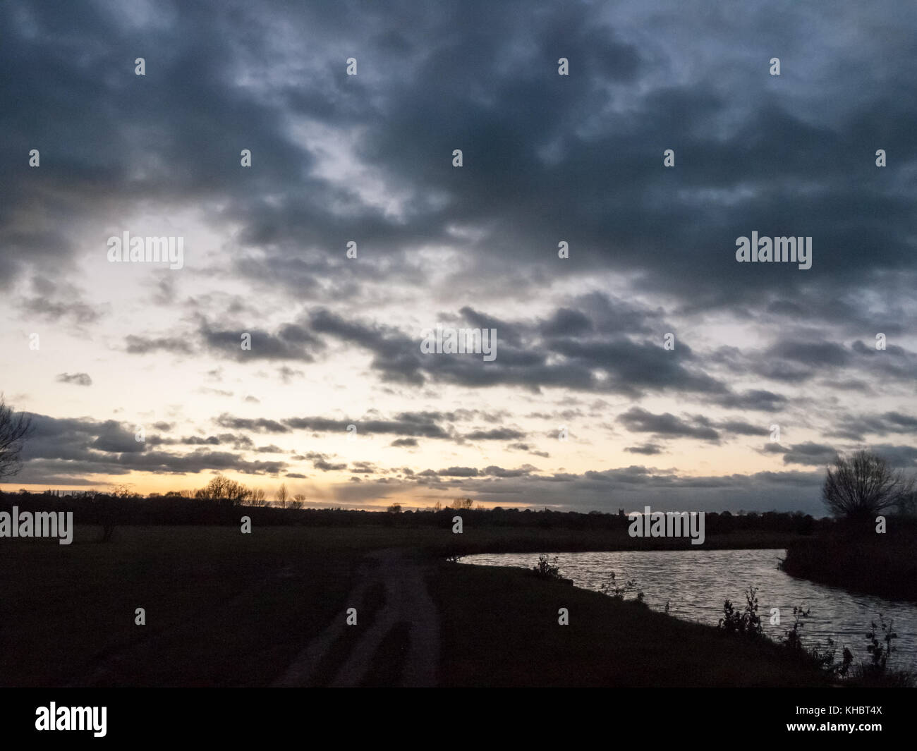 dramatic sun set night sky countryside side of river; essex; england
