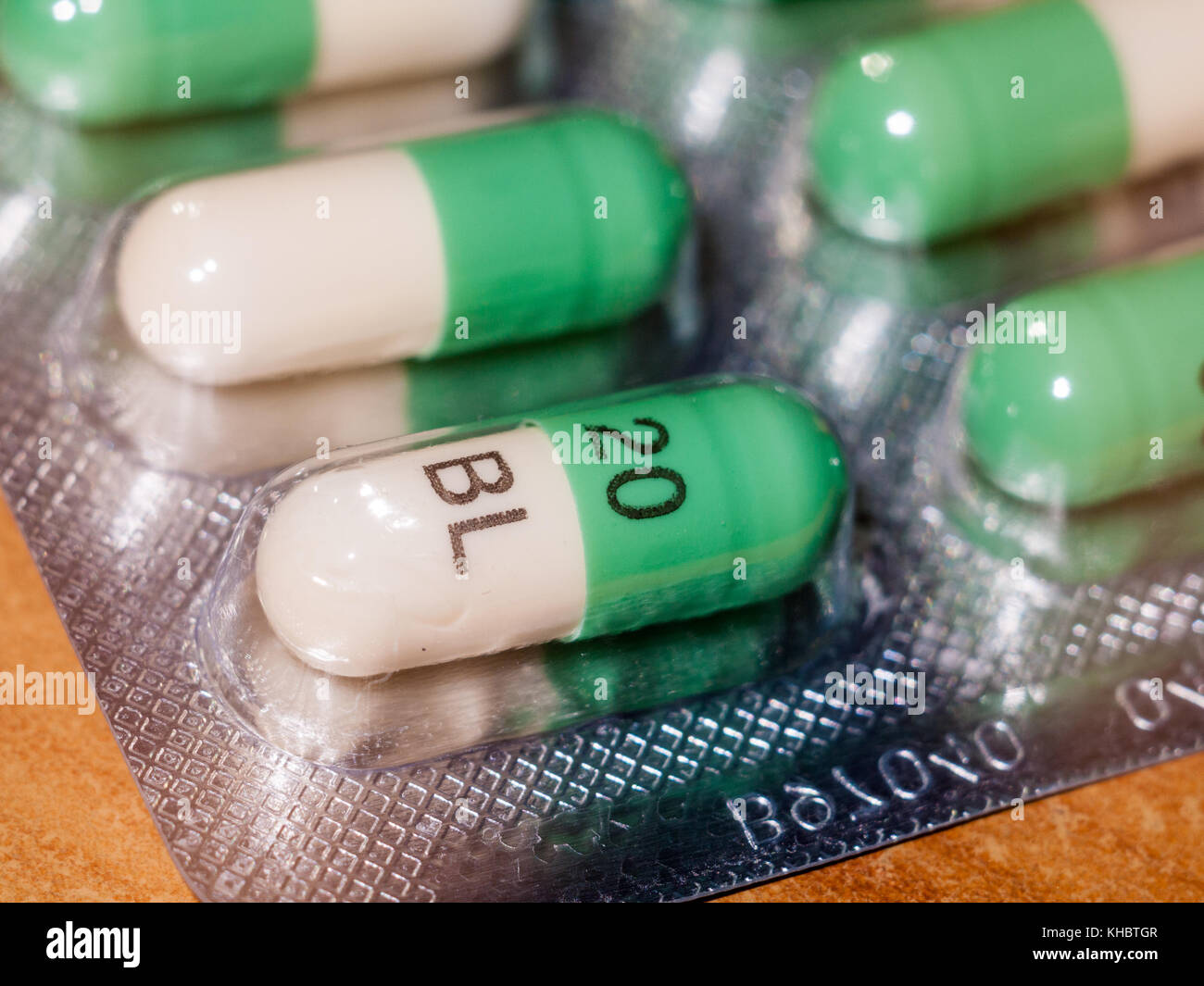 close up detail of foil packet of green and white prozac painkiller