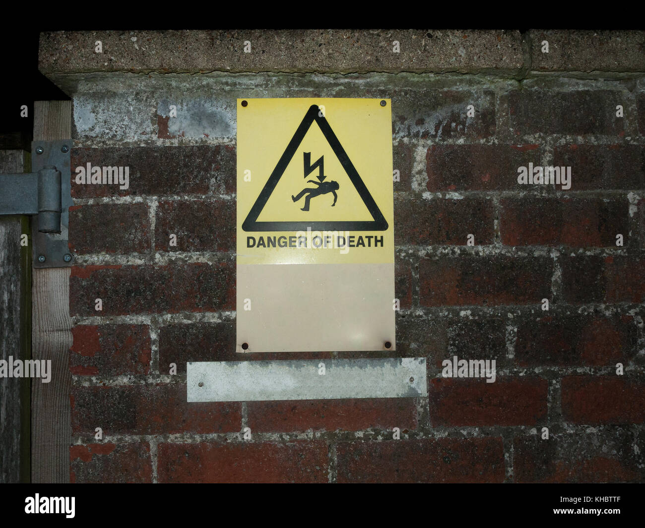 outside yellow danger of death warning sign wall; essex; england; uk Stock Photo