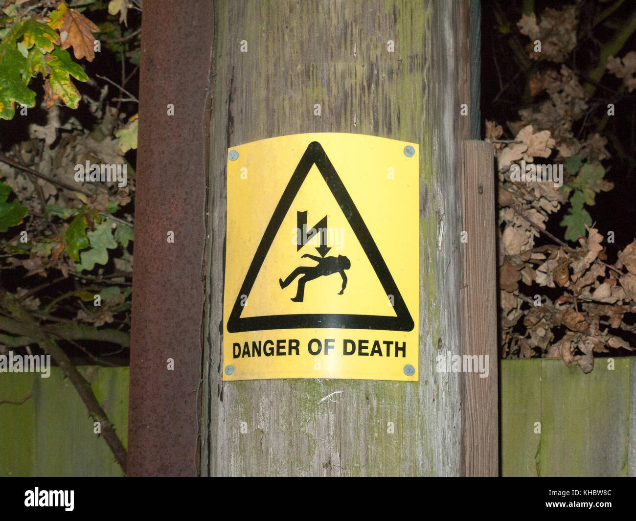 yellow danger of death safety sign outside pole electricity shock; essex; england; uk Stock Photo