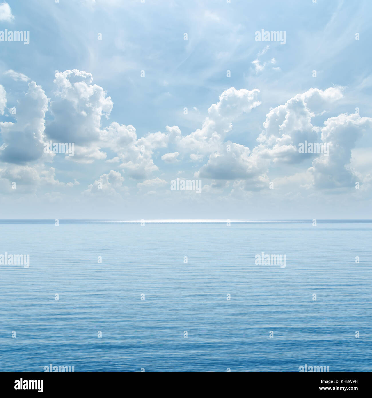 blue sea and cloudy sky over it Stock Photo - Alamy