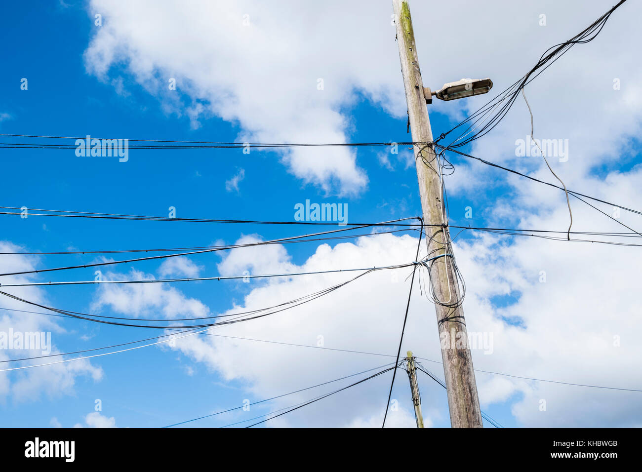 Many electricity power cables on a wooden utility pole with a light, Nottingham, England, UK Stock Photo