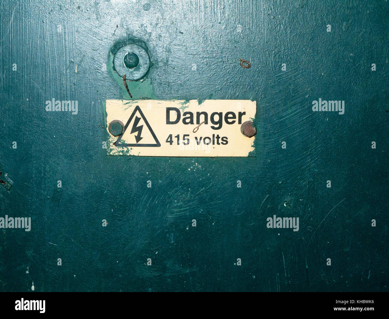bunch of safety signs water green box yellow triangle; essex; england; uk; danger 415 volts Stock Photo