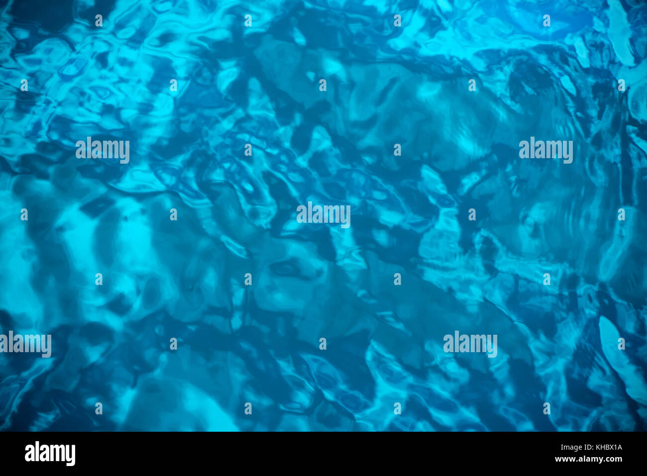 Blue abstract water surface with ripples and waves as background, top ...