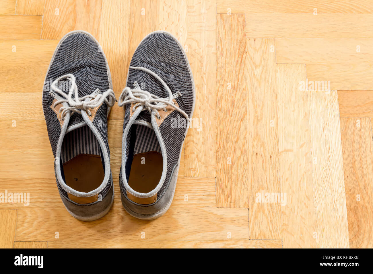A pair of used sneakers on the floor Stock Photo - Alamy