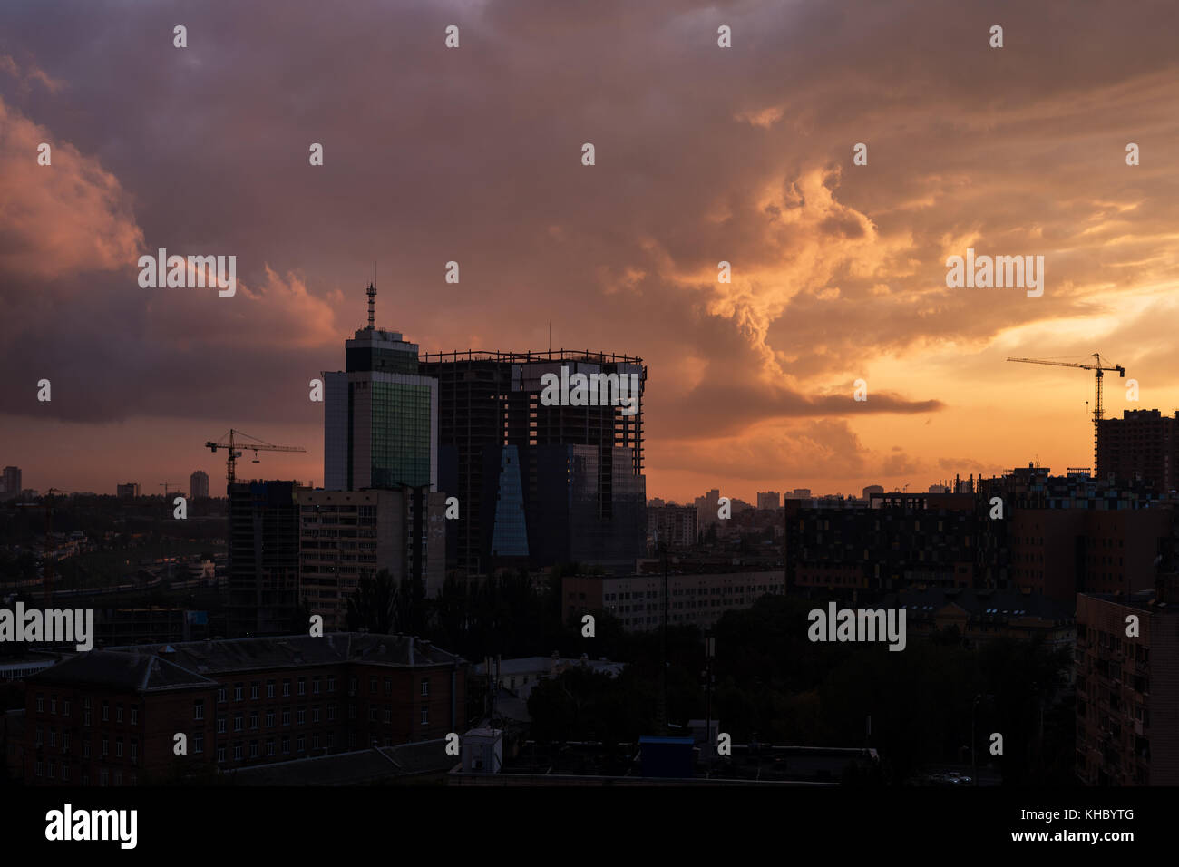 Colorful dramatic sky with clouds at sunset over the urban landscape ...
