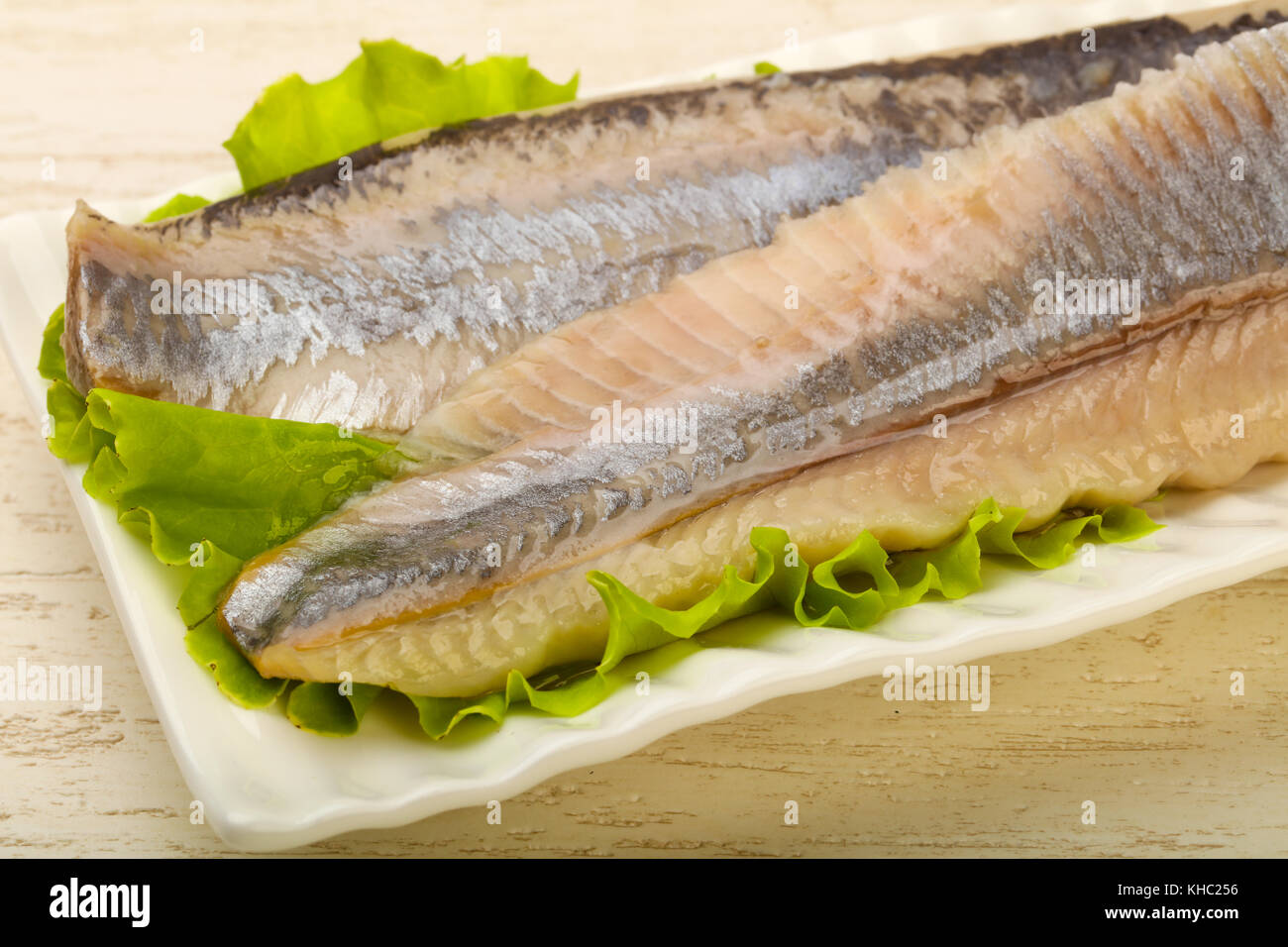 Herring fillet over salad leaves ready for eat Stock Photo Alamy