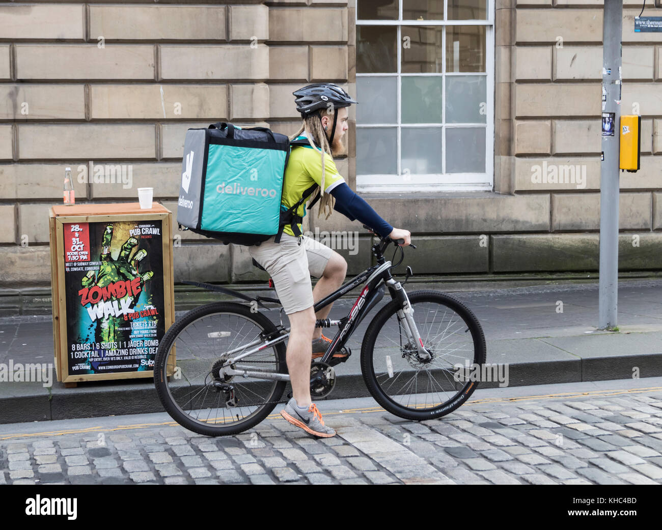 Deliveroo rider on The Royal Mile in Edinburgh, Scotland. UK Stock Photo