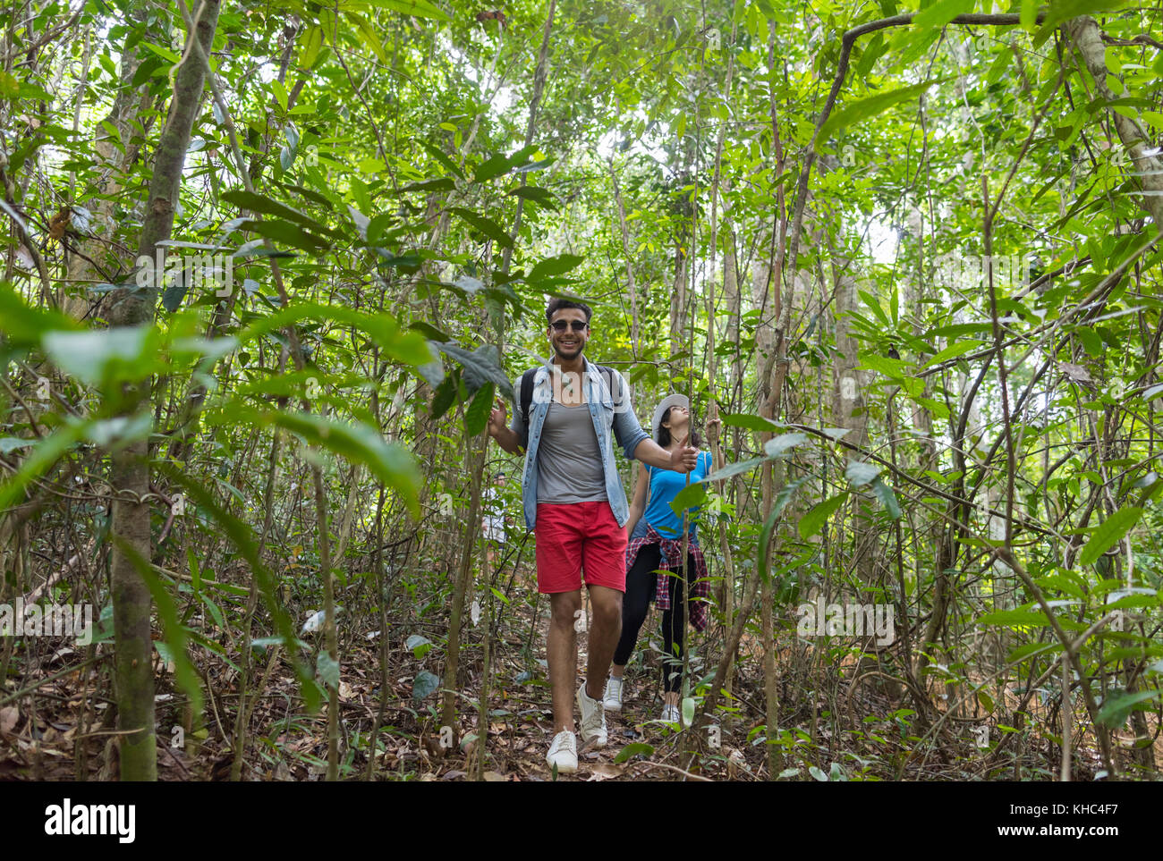 Couple With Backpacks Trekking On Forest Path, Young Man And Woman ...