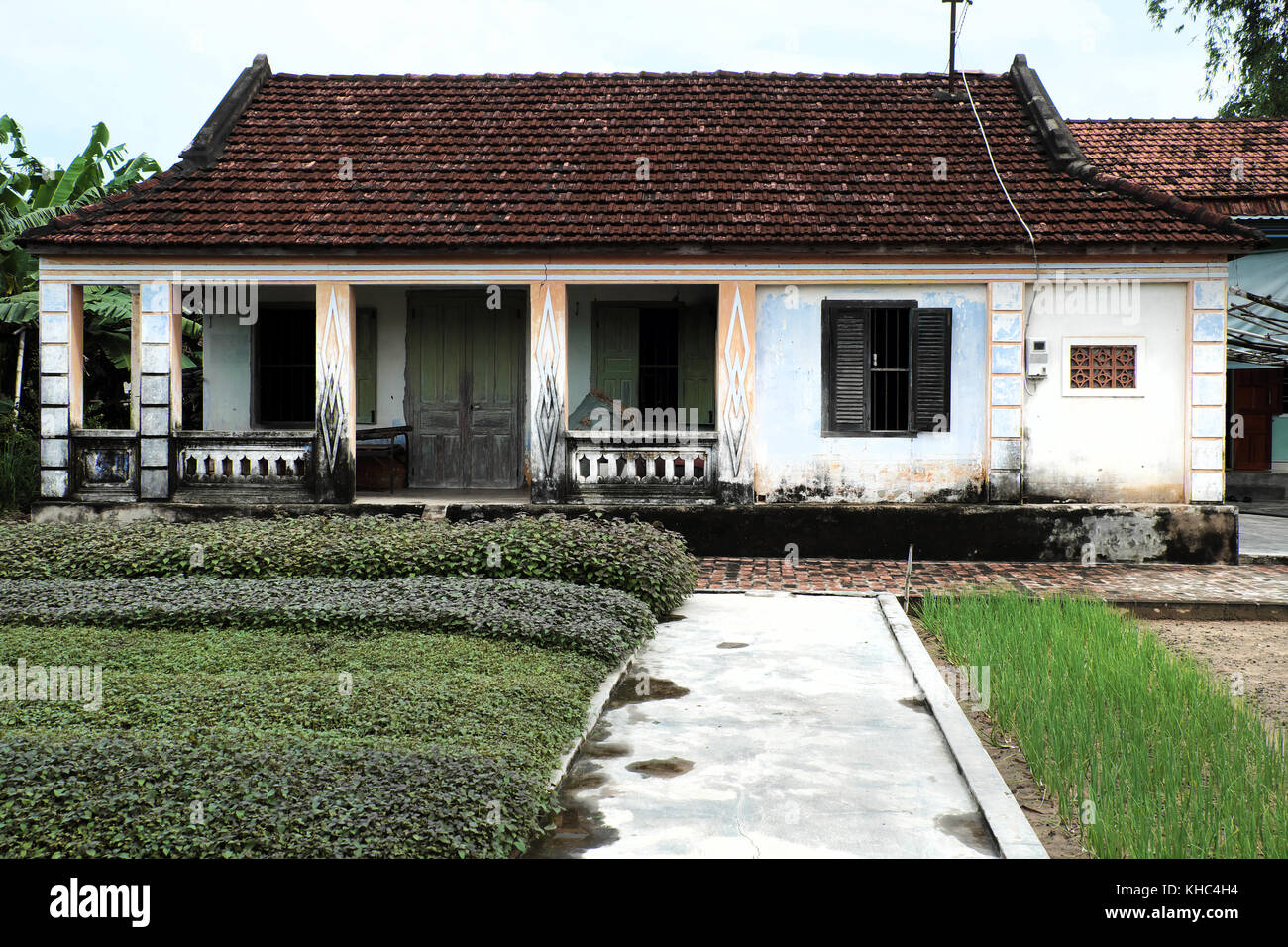 Vietnamese ancient house with wood door, wooden window and vegetable