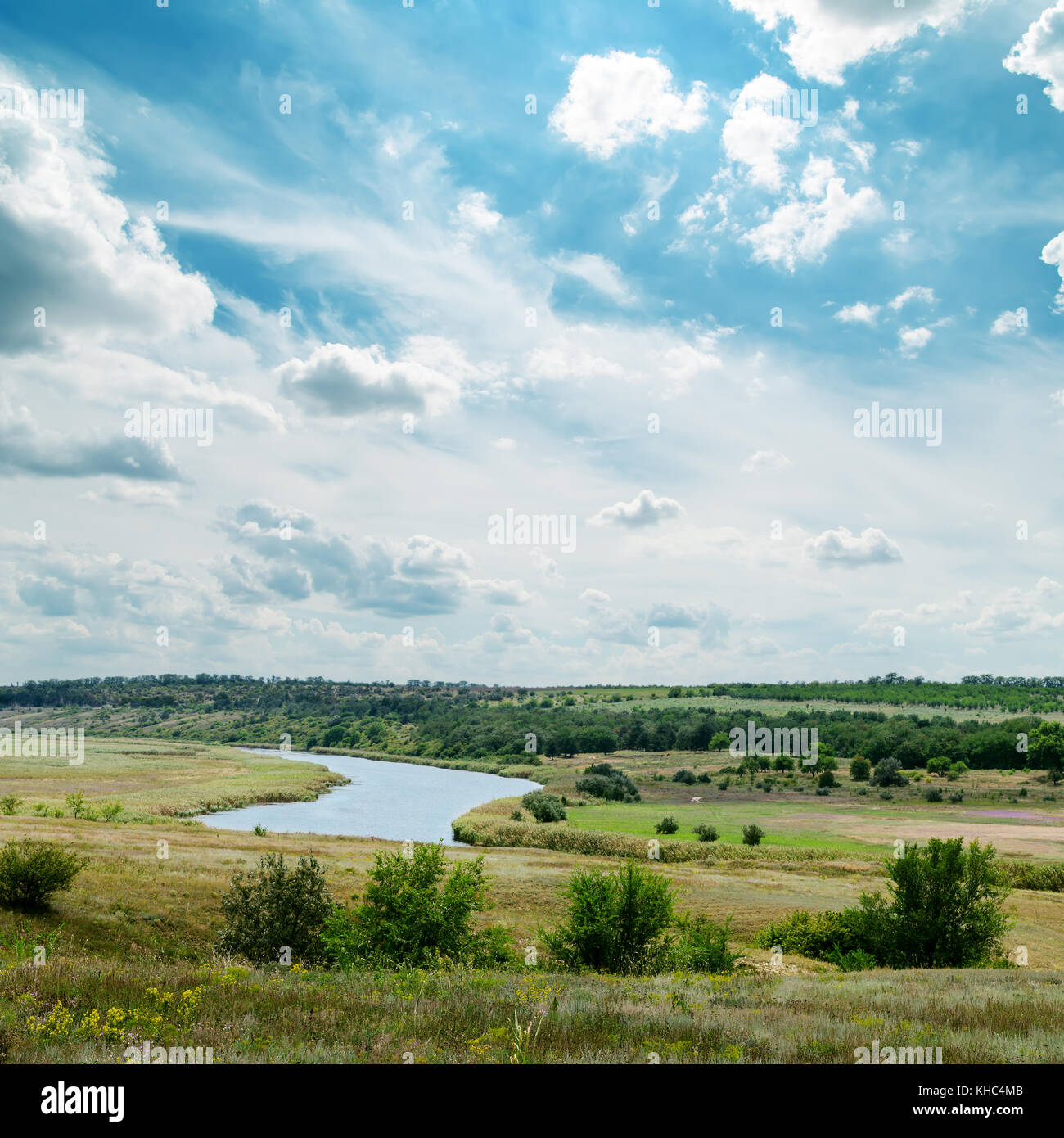 green landscape with river and cloudy sky Stock Photo - Alamy