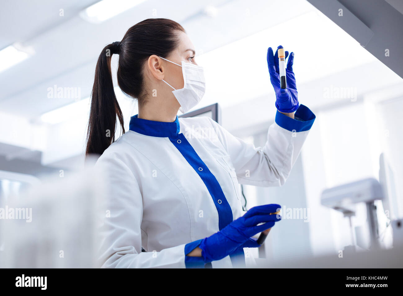 Laboratorian Focused laboratorian examining blood sample Stock Photo - Alamy