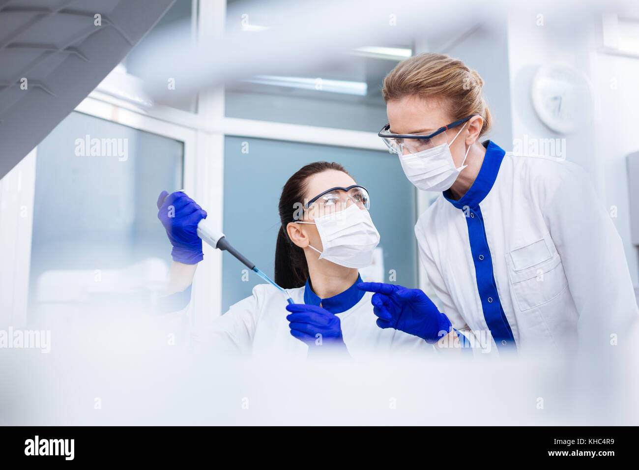 Sharing A Lab Smart beautiful laboratorian sharing experience with colleague Stock ...
