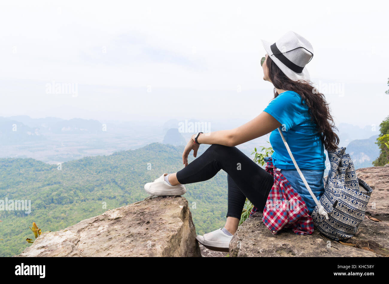 Girl sitting on mountain top hi-res stock photography and images - Alamy