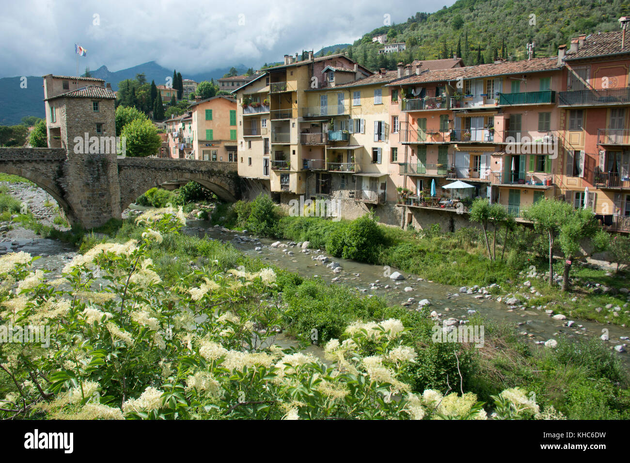 Old bridge of Sospel *** Local Caption *** France, Alpes du Sud, Sospel, village, bridge, river, houses, old, flowers, spring Stock Photo