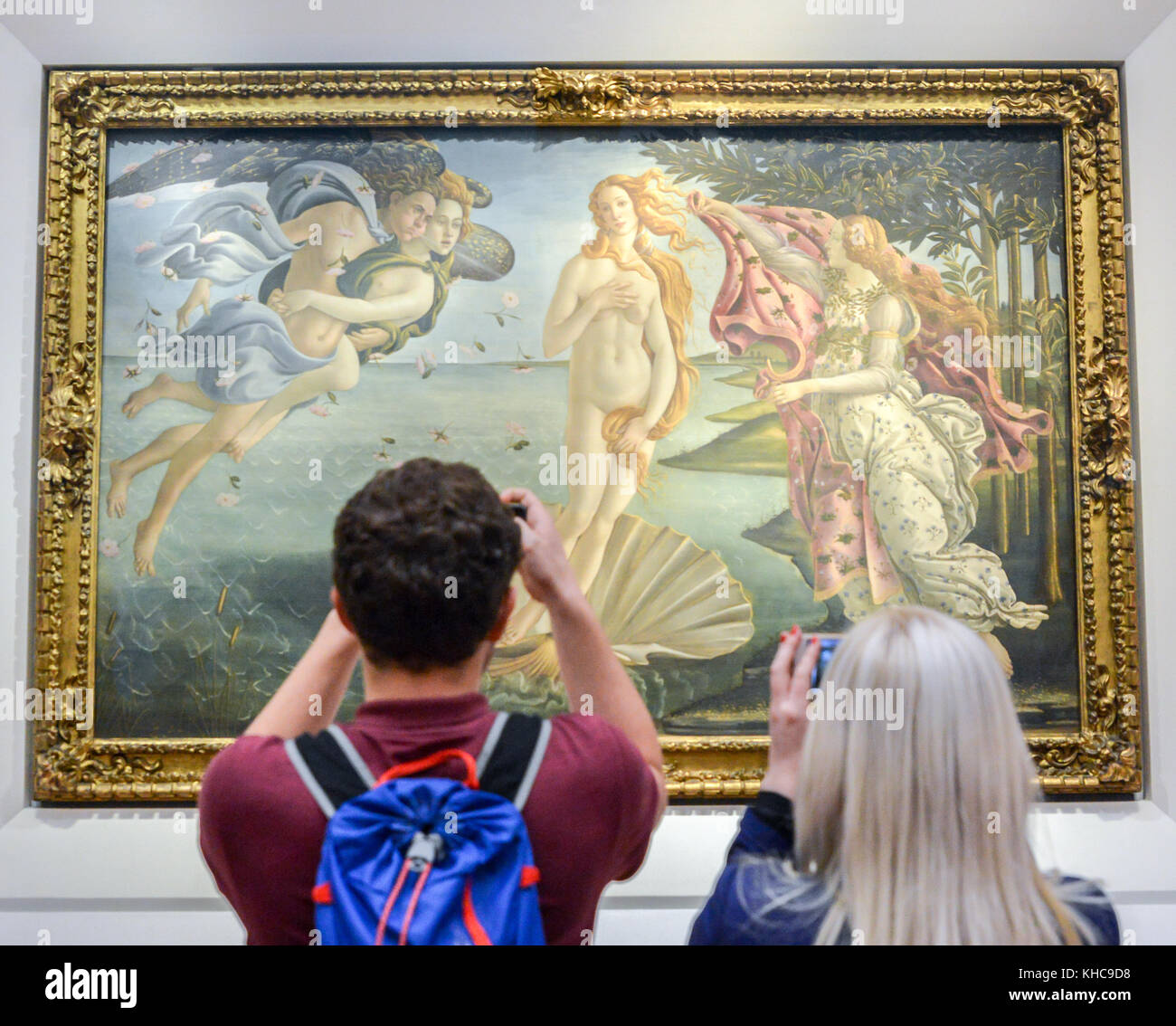 Florence, Italy - October 31st, 2017: Man takes a selfie in front of Birth of Venus by Botticelli at Uffizi Galleries in Florence, Tuscany, Italy Stock Photo