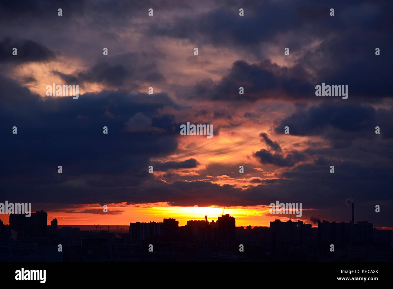 Sunset over the city. Stormy clouds, background Stock Photo - Alamy