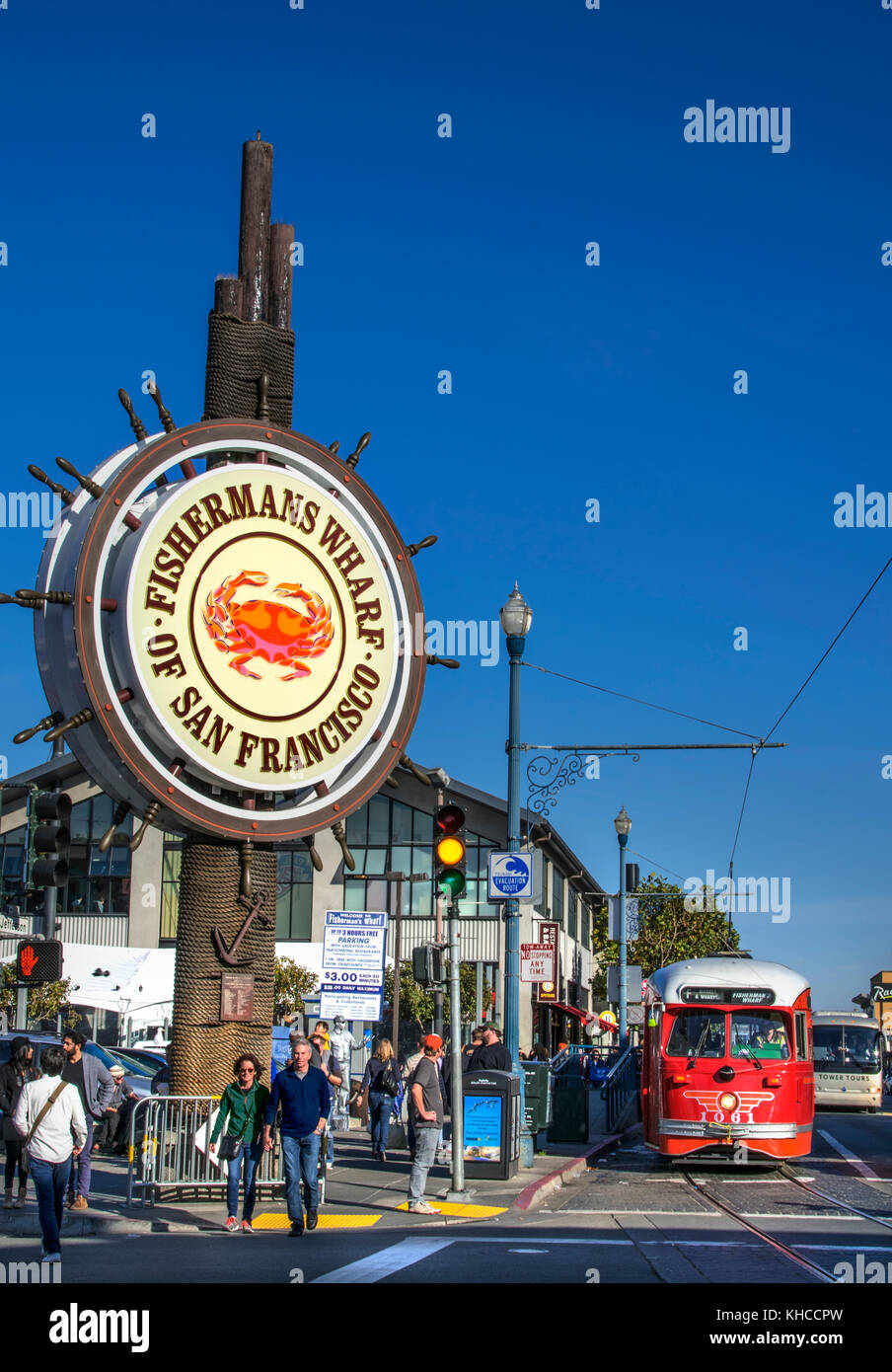 Fisherman's Wharf entrance and sign with vintage red city tour tram and tourists San Francisco California USA Stock Photo