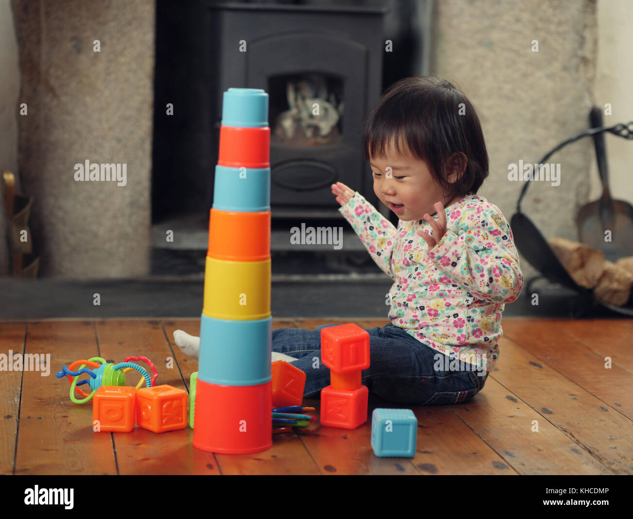 baby girl playing stacking cups at home Stock Photo Alamy