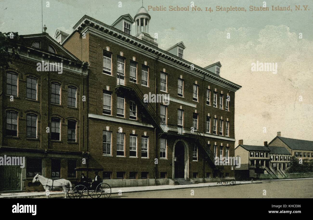 A postcard from a tinted photograph of the exterior of Public School No 14, the school is a four story brick faced building, another three story building stands attached, a horse drawn carriage can be seen standing still on the street, large homes can be seen down the street, Stapleton, Staten Island, New York, 1900. From the New York Public Library. Stock Photo