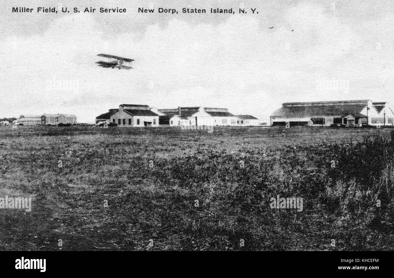 A postcard from a photograph of Miller Field, it was an airfield that was completed in 1921 and used by the United States Army Air Service, it was added to the National Register of Historic Places in 1980, in the image a bi-wing plane is shown flying over the airfield and it's hangers, 1900. From the New York Public Library. Stock Photo