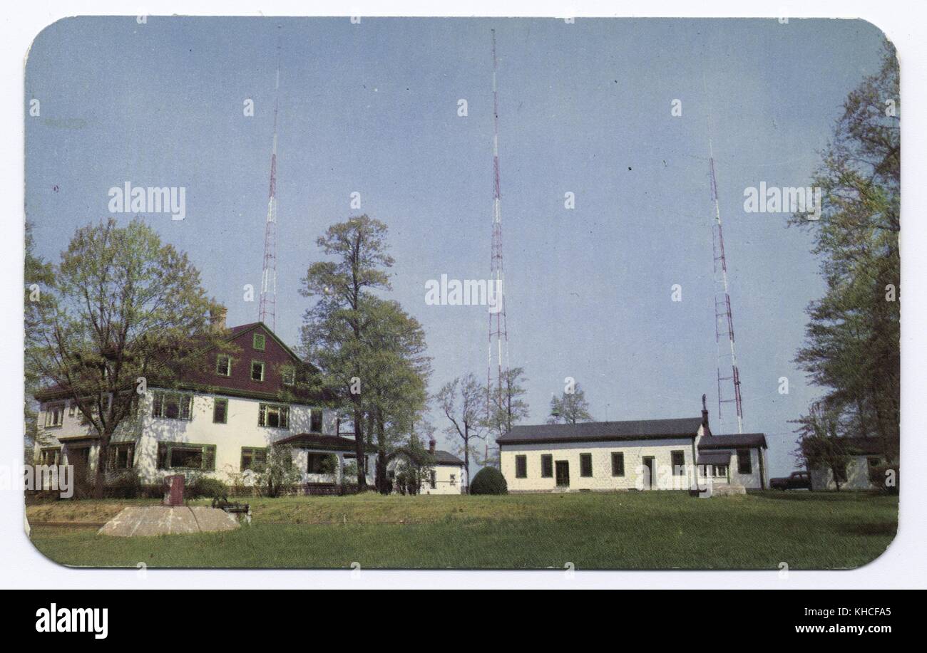 A postcard featuring a photograph of the WBBR Radio Station, four buildings  are seen on the property along with three transmission towers, they are  situated on a neatly kept lawn with several