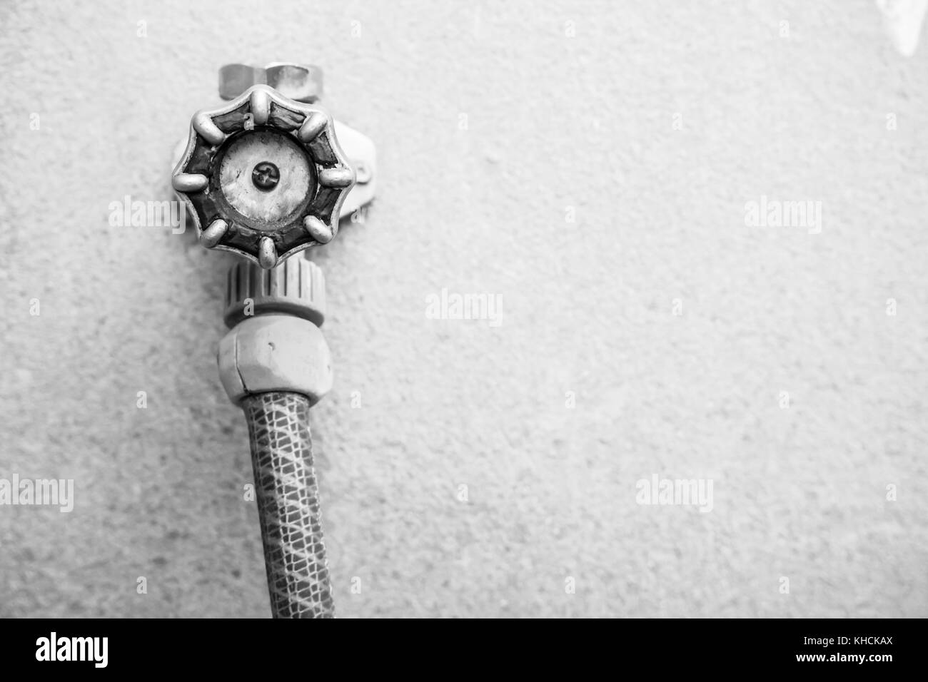 Exterior spigot or faucet with garden hose attached Stock Photo Alamy