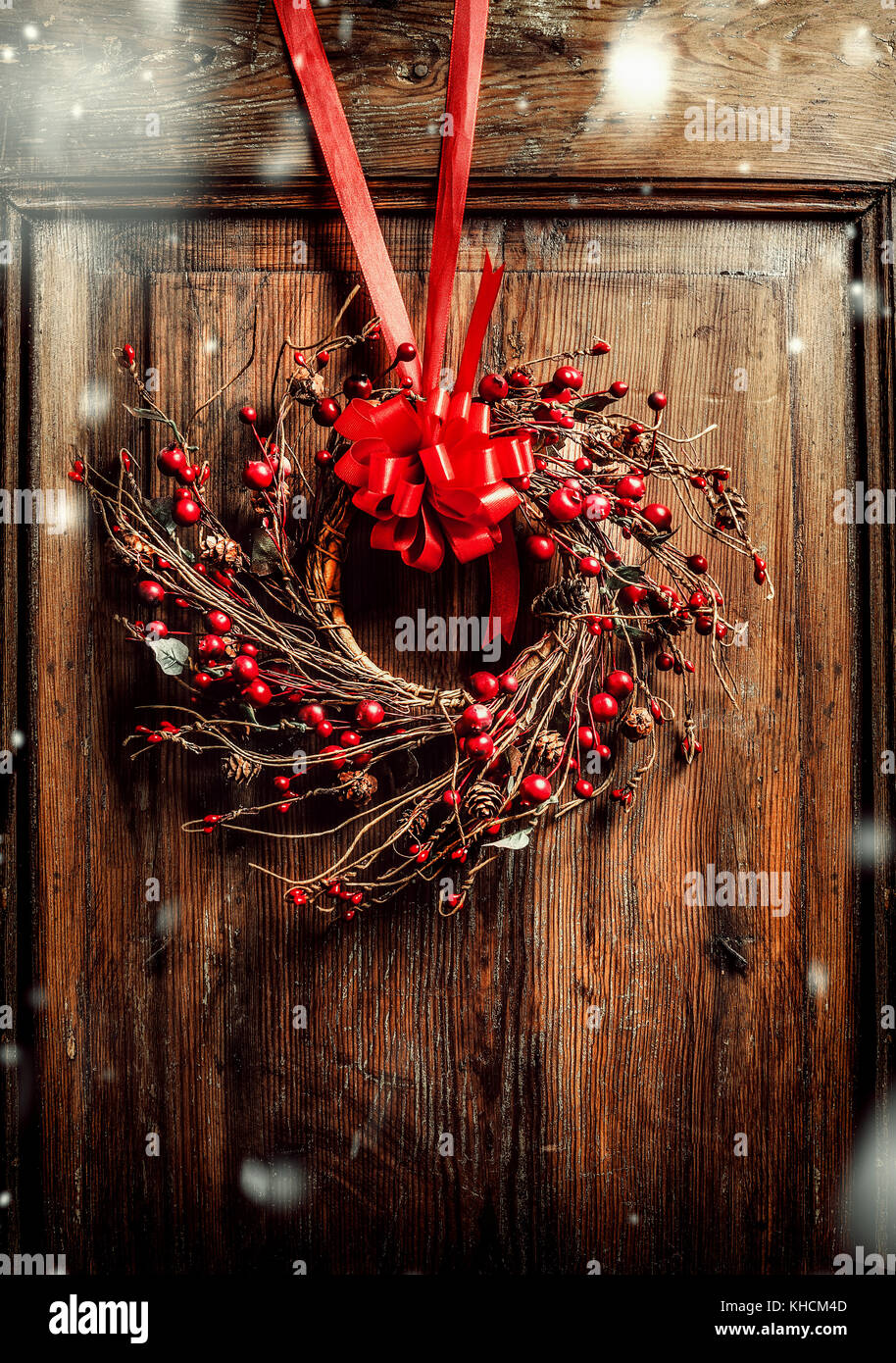 Handmade Christmas Wreath Hanging On Aged Old Wooden Door