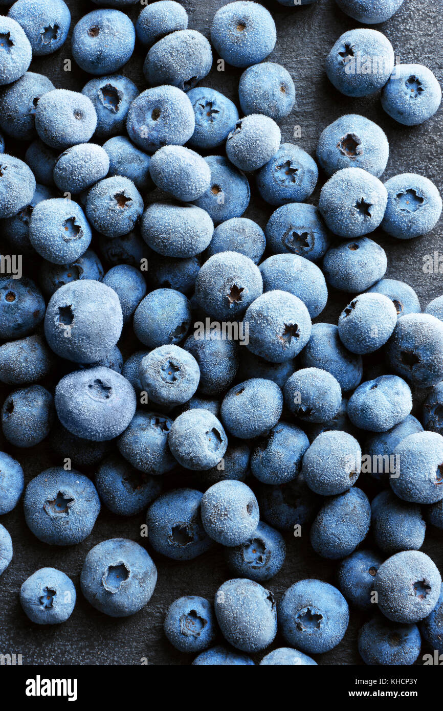 Frozen blueberry on black slate. Close up. Top view. High resolution product. Stock Photo