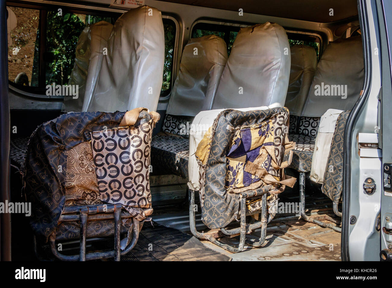 Completely broken seats that are still used for transporting people in a minibus in Uganda Stock Photo