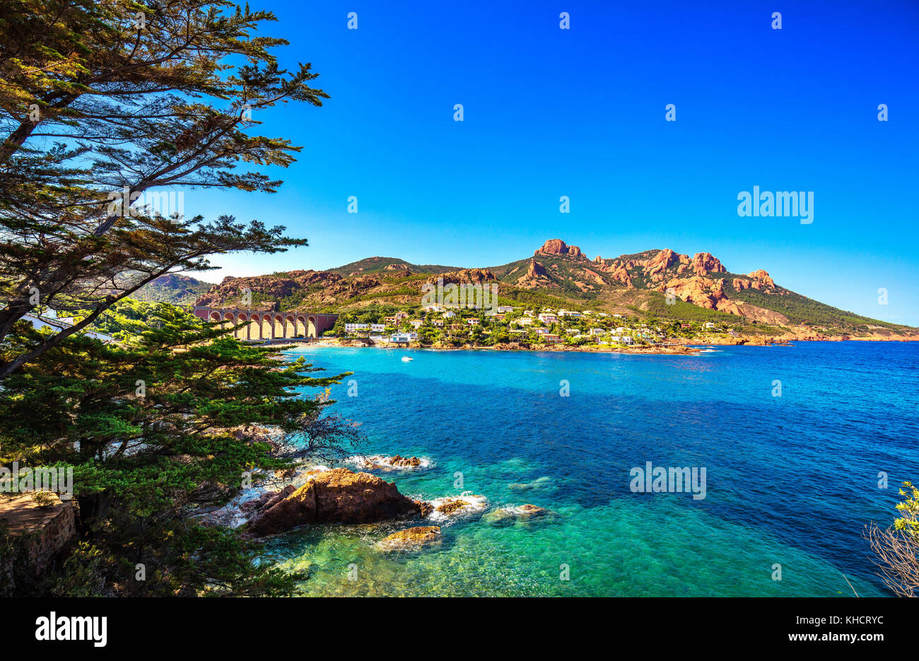 Esterel mediterranean red rocks coast, beach, tree and sea. French Riviera in Cote d Azur near Cannes Saint Raphael, Provence, France, Europe. Stock Photo