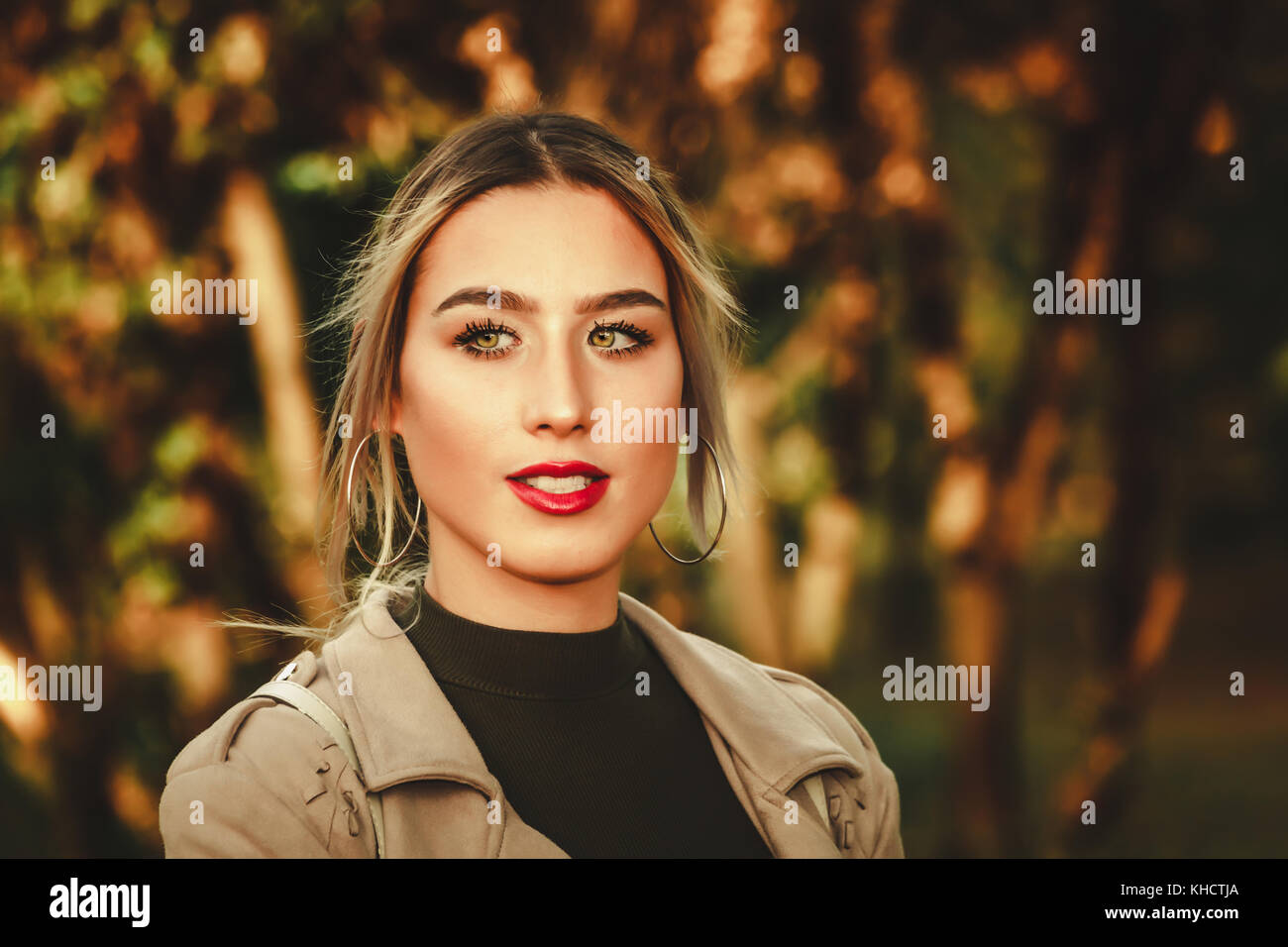 Close up portrait of a beautiful young modern and urban woman outside ...