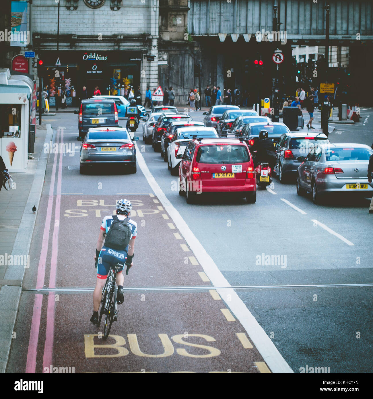 A cyclist commuting at a busy crossing in London Bridge area. London, 2017. Square format. Stock Photo