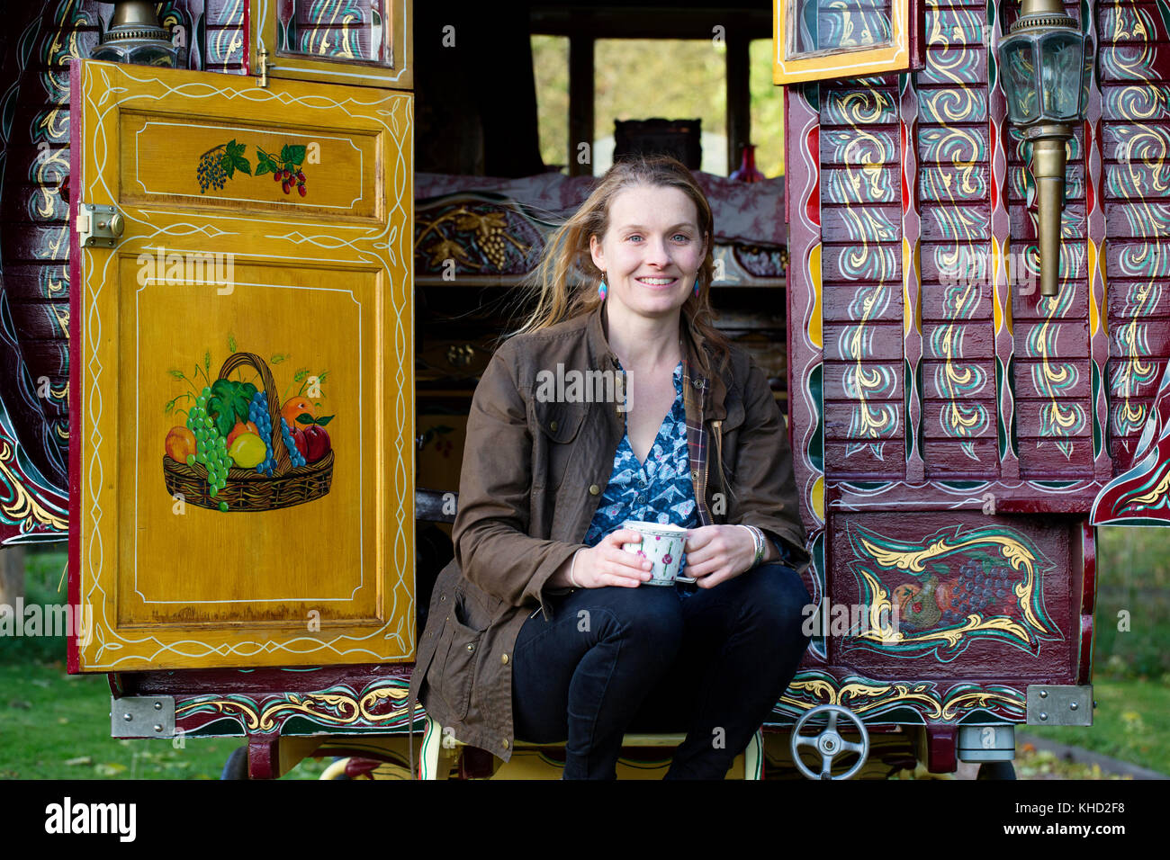 Woman sitting on traditional gypsy caravan, portrait Stock Photo