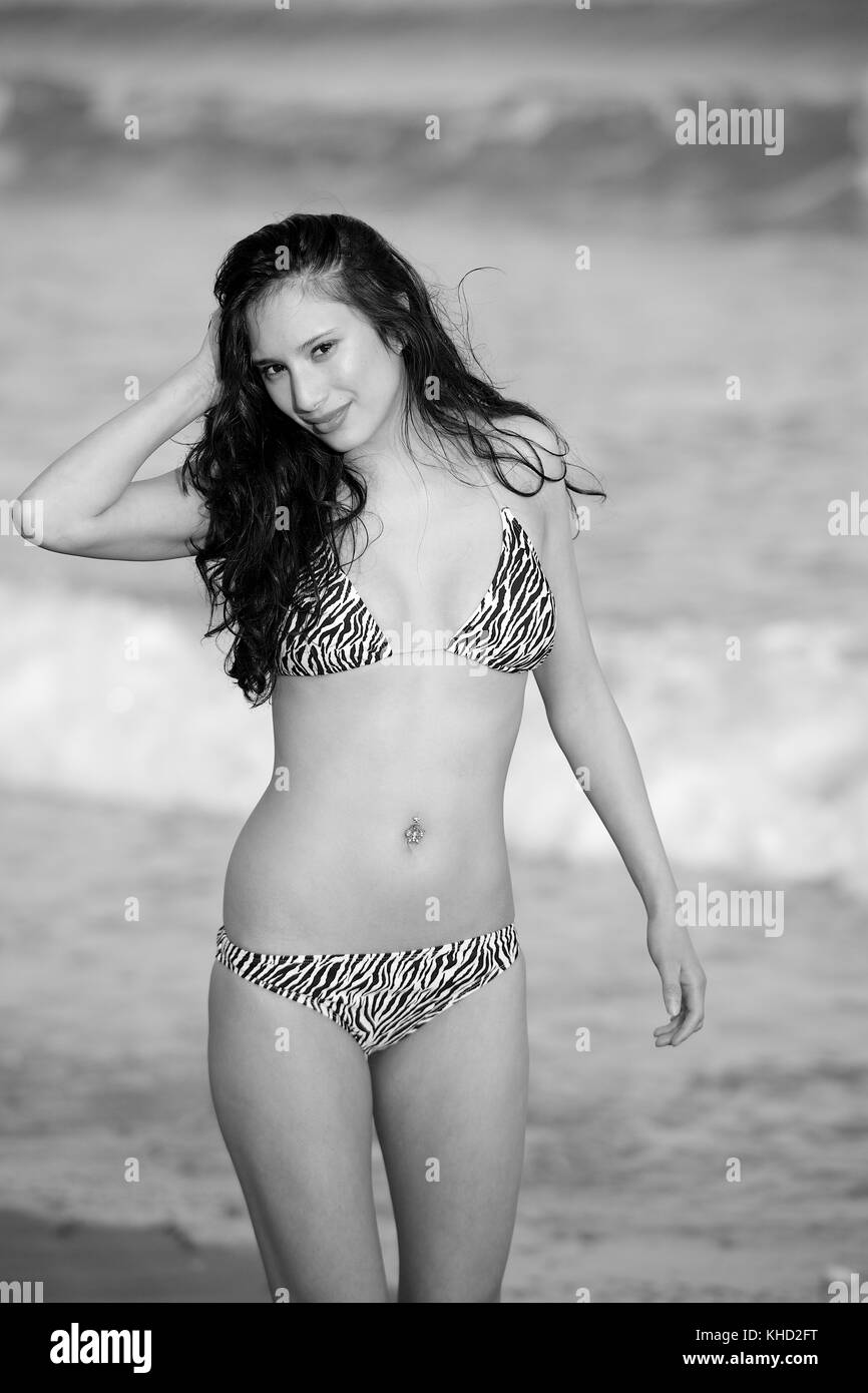 Beautiful brunette girl in a bikini on the beach Stock Photo - Alamy