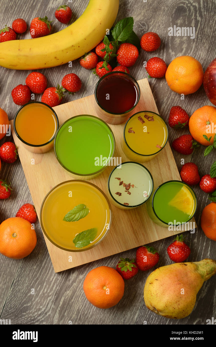 assorted fruit juices with ingredients around closeup Stock Photo Alamy