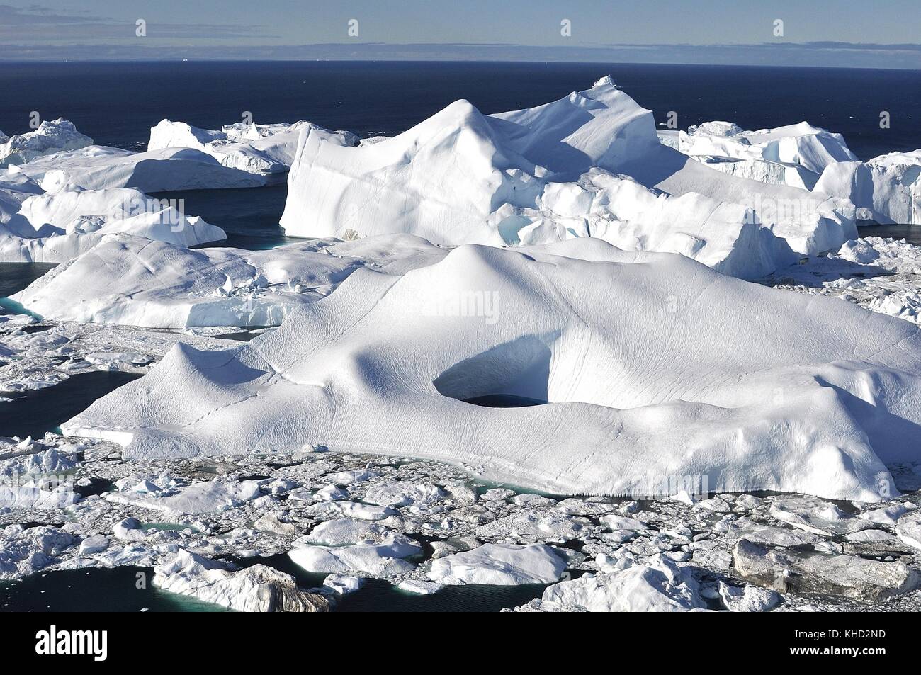 ICEBERGS ABOUT TO CALVE INTO DISKO BAY FROM ILULISSAT GLACIER Stock Photo