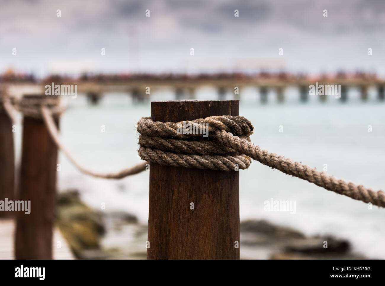 Pier poles and ropes on the bridge in Mexico. Another bridge blurred in