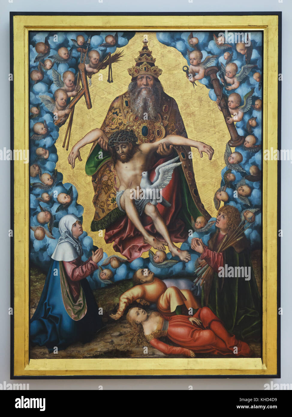 Painting 'The Holy Trinity' by German Renaissance painter Lucas Cranach the Elder from circa 1515 on display in the Museum der bildenden Künste (Museum of Fine Arts) in Leipzig, Saxony, Germany. The Holy Trinity is depicted worshipped by the Virgin Mary and Saint Sebastian. Stock Photo