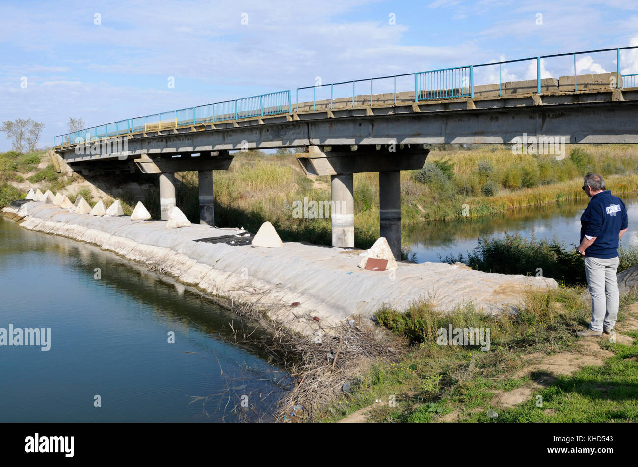 OSCE representative looking at the temporary dam over the North Crimean Canal near Ukrainian-Russian border in Crimea. October 7, 2016. Ukraine Stock Photo