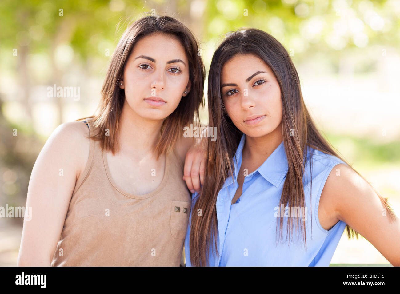 Two Beautiful Ethnic Twin Sisters Portrait Outdoors. Stock Photo